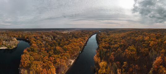 Aerial epic panorama of autumn river valley and colorful golden forest