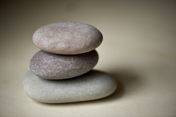 Fototapeta na wymiar Stack, studio or stones at spa for healing, massage or wellness treatment therapy for balance. Pile, aromatherapy and rocks for a calm, zen or peace atmosphere at a natural salon on grey background