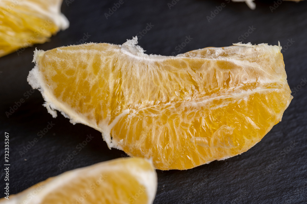 Wall mural peeled slices of ripe and juicy orange close-up