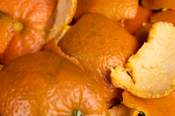 a large number of orange citrus fruits on a black slate surface