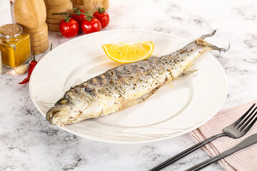 Grilled sea bass fish served lemon