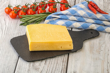 Piece of natural organic cheese over board