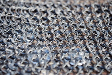 Fragment of the chain mail of a medieval knight close-up