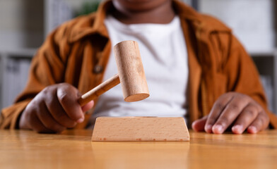 Hand of black boy holding gavel, Child protection law, Juvenile Court, Dream career concept.