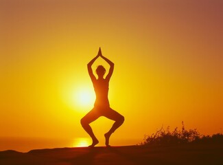 Silhouette of a girl in a yoga pose against the backdrop of a bright sunset by the sea.