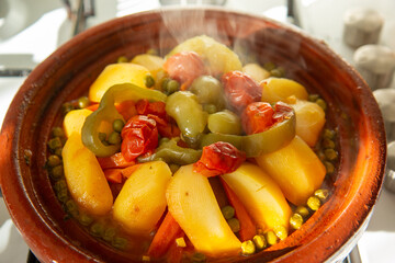 Moroccan cuisine tajine vegetables with meat cooked in typical North African terracotta pan - 732341944