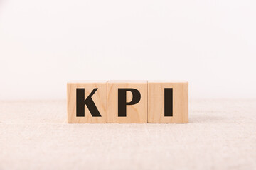 CONCEPT KPI inscription on wooden cubes on a light background