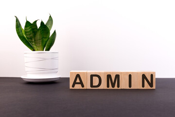 ADMIN word built with letter cubes on a black table