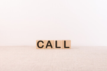 CALL written in wooden cubes on a light background