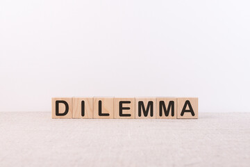 DILEMMA word from building blocks on a light background