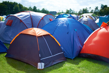 Group, colourful and camping tents in nature outside of a music festival campsite. Row of canopies...