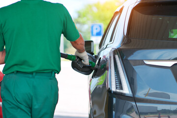 Man refilling the car with fuel at the refuel station