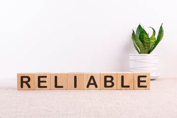 RELIABLE word made with building blocks on a light background
