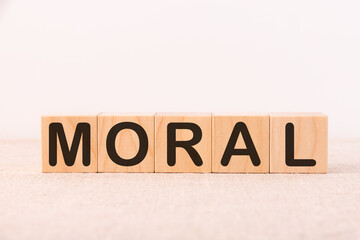 Moral word concept written on wooden cubes on a light table and a light background