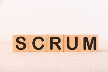 Scrum word concept written on wooden cubes on a light table and light background