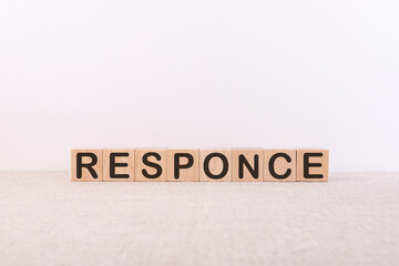 RESPONCE word concept written on wooden cubes on a light table and a light background