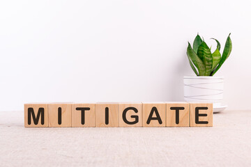 MITIGATE word made with building blocks on a light background