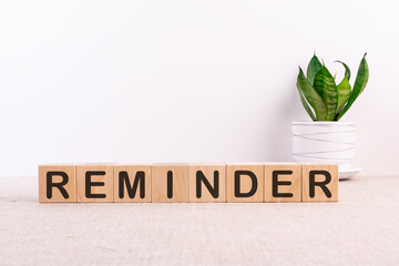 REMINDER word made with building blocks on a light background