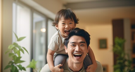 Ecstatic Asian father having a blast with his young son in the living space, bonding and enjoying quality time at their residence. - obrazy, fototapety, plakaty