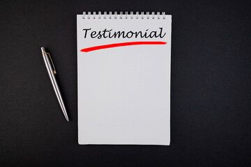 Lettering concept testimonial notebook and pen top view.