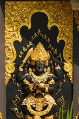 Guardian figurines protector of the place The walls of the Buddhist chapel are magnificent, beautiful, and are Buddhist art. Wat Phra That Doi Prachan. Located at Lampang Province in Thailand.