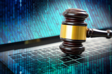 Laws regarding cyber crimes, Justice gavel on laptop computer keyboard