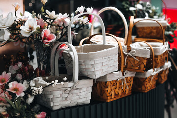 Wicker baskets and spring flowers on a store counter