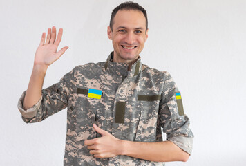 Ukrainian soldier wearing military uniform with flag and chevron depicting trident - Ukrainian...