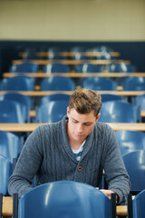 Writing, college and man student in classroom brainstorming for exam studying ideas. Planning,...