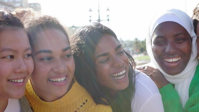 Slow motion footage of young women friends bonding together at city street. Female friendship and diversity people concept. High quality 4k footage