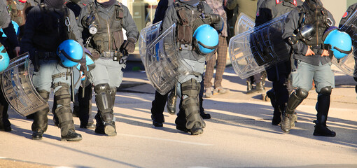 police in riot gear during the protest demonstration with helmets and shields on the road