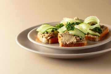 Toasts with pate on a beige background.