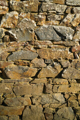 Old stone wall made of rocks close up