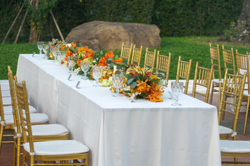 Beautiful flowers decorated on the table.Tables set for an event party or 
wedding reception luxury elegant table setting dinner in a restaurant
