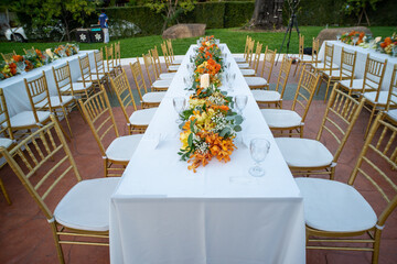 Beautiful flowers decorated on the table.Tables set for an event party or 
wedding reception luxury elegant table setting dinner in a restaurant