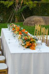Beautiful flowers decorated on the table.Tables set for an event party or 
wedding reception luxury elegant table setting dinner in a restaurant