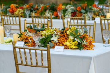 Beautiful flowers decorated on the table.Tables set for an event party or 
wedding reception luxury elegant table setting dinner in a restaurant