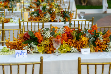 Beautiful flowers decorated on the table.Tables set for an event party or 
wedding reception luxury elegant table setting dinner in a restaurant