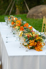 Beautiful flowers decorated on the table.Tables set for an event party or 
wedding reception luxury elegant table setting dinner in a restaurant