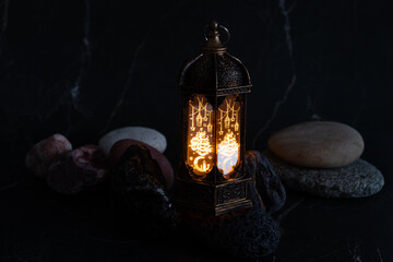 Ramadan lantern with stones, arabesque design, candle glow, Ramadan celebration