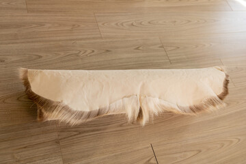 The soft reindeer skin is rolled up. White leather