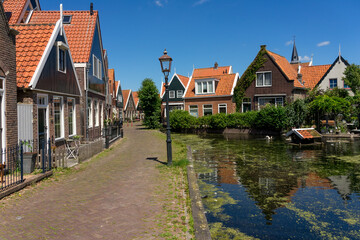 Fototapeta na wymiar Beautiful fishing village of Volendam with with its typical houses in a sunny day. Netherlands.