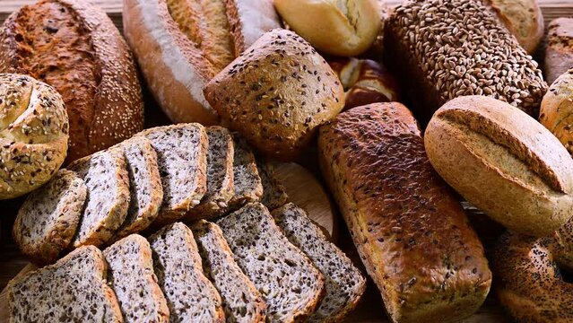 Assorted bakery products including loaves of bread and rolls.