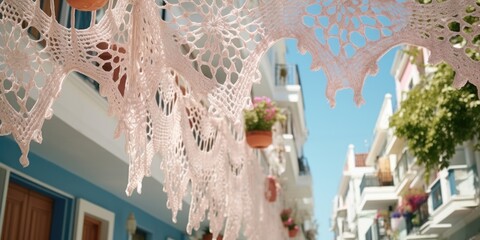 A row of white crocheted doilies hanging gracefully from a building. Perfect for adding a touch of vintage charm to any space - obrazy, fototapety, plakaty