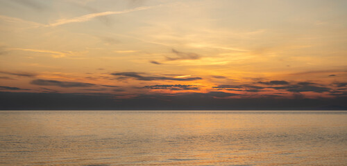 Tranquil scene of beautiful sea at sunset. Orange and yellow sunset on the sea. Aerial panoramic view of sunset over sea.