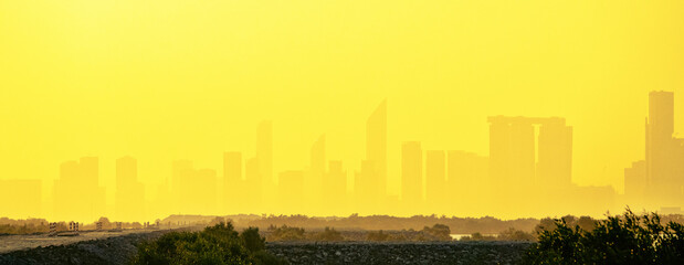 Sandstorm, samum, haboob over the southern megalopolis, the outline of skyscrapers are drowning in...