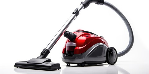 A compact, powerful vacuum cleaner in vibrant red and black colors placed on a clean white surface. Ideal for household cleaning tasks.