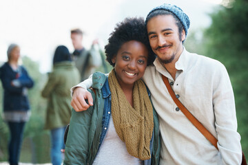 Students, university and portrait of interracial couple of friends on campus with hug and an...