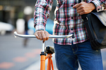 Hands, person and push bike in street to travel on eco friendly transport outdoor, commute or...