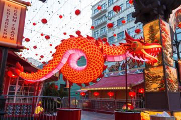 Chinese New Year in Moscow. Festive decoration of Kamergersky lane. The glowing Chinese dragon is a symbol of the good beginning of Yang. Russia - 732419788